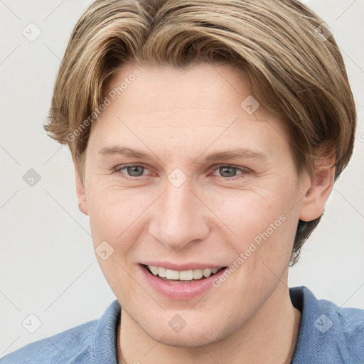 Joyful white young-adult female with short  brown hair and blue eyes