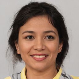 Joyful asian young-adult female with medium  brown hair and brown eyes