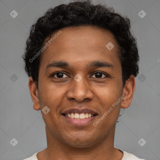 Joyful latino young-adult male with short  black hair and brown eyes