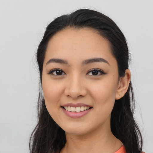 Joyful asian young-adult female with long  black hair and brown eyes