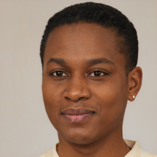 Joyful black young-adult female with short  black hair and brown eyes