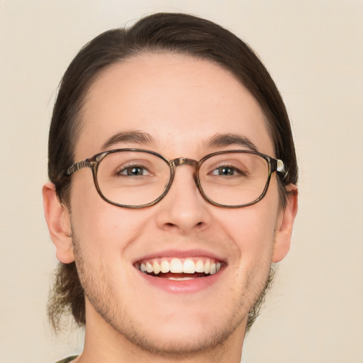 Joyful white young-adult male with short  brown hair and green eyes