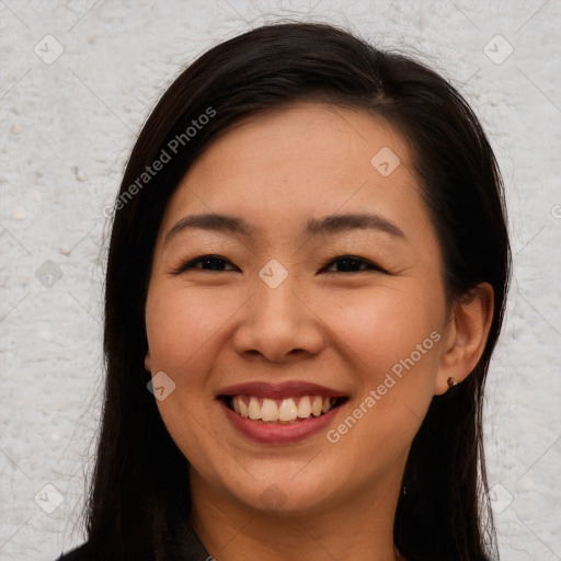 Joyful asian young-adult female with long  brown hair and brown eyes