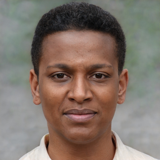 Joyful black young-adult male with short  brown hair and brown eyes