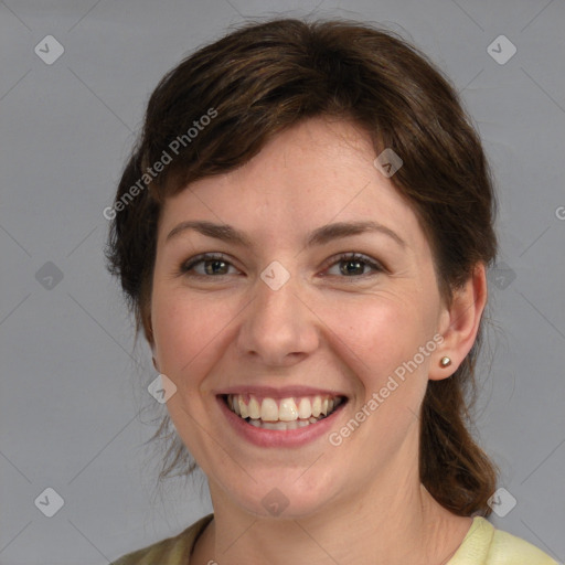 Joyful white young-adult female with medium  brown hair and green eyes