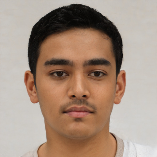 Neutral latino young-adult male with short  black hair and brown eyes