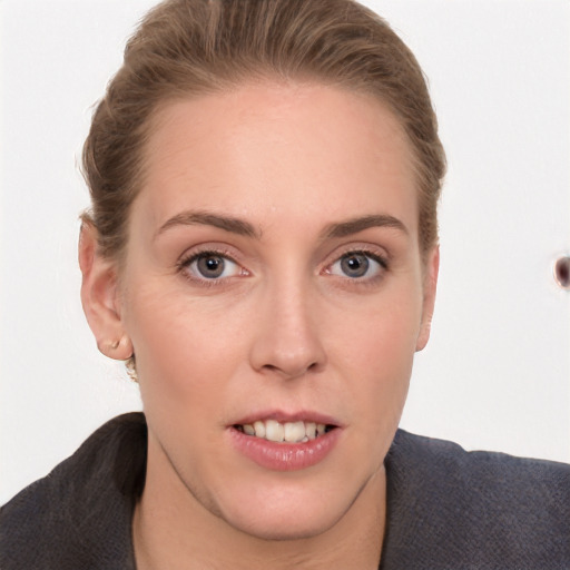 Joyful white young-adult female with short  brown hair and grey eyes