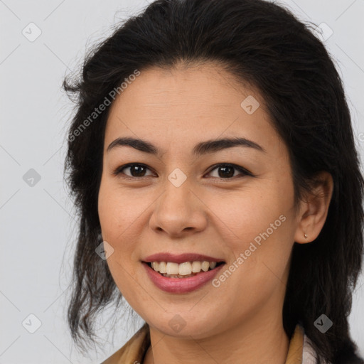 Joyful latino young-adult female with long  brown hair and brown eyes