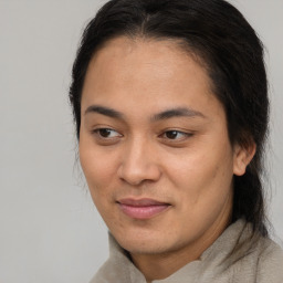 Joyful latino adult female with medium  brown hair and brown eyes