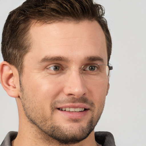 Joyful white young-adult male with short  brown hair and grey eyes