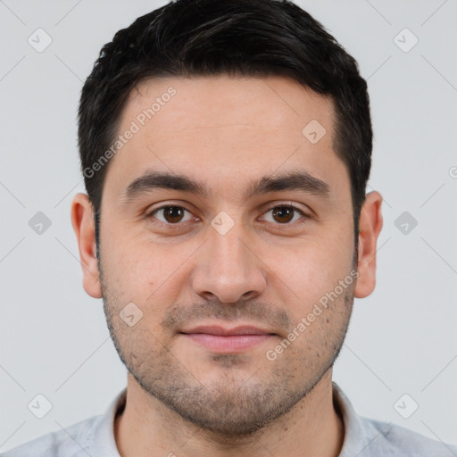 Joyful white young-adult male with short  black hair and brown eyes