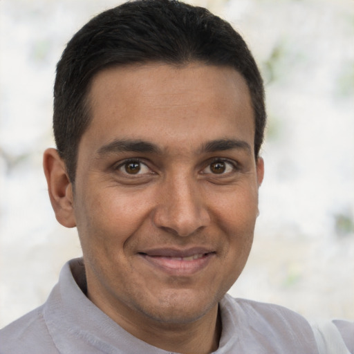Joyful latino young-adult male with short  brown hair and brown eyes