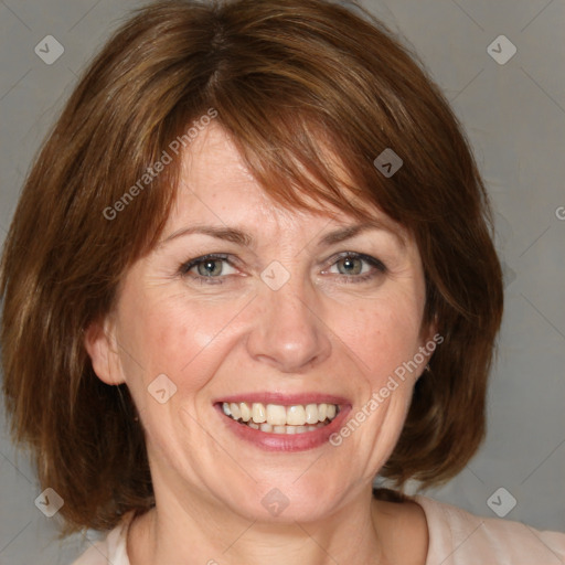 Joyful white adult female with medium  brown hair and blue eyes