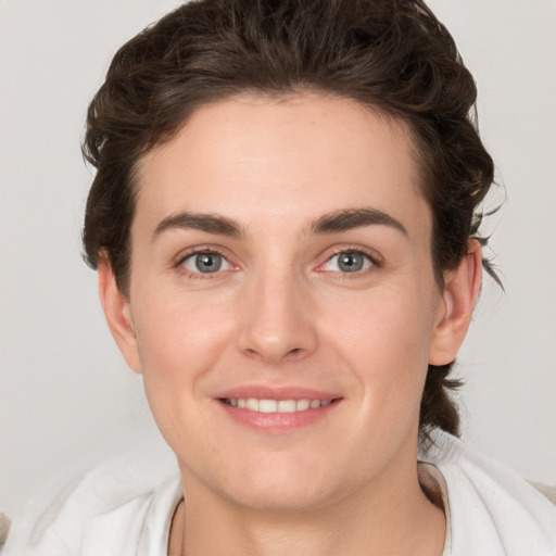 Joyful white young-adult female with medium  brown hair and green eyes