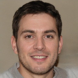 Joyful white adult male with short  brown hair and brown eyes