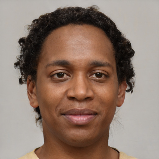 Joyful black young-adult male with short  brown hair and brown eyes