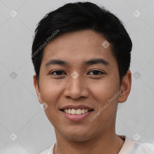 Joyful asian young-adult male with short  black hair and brown eyes