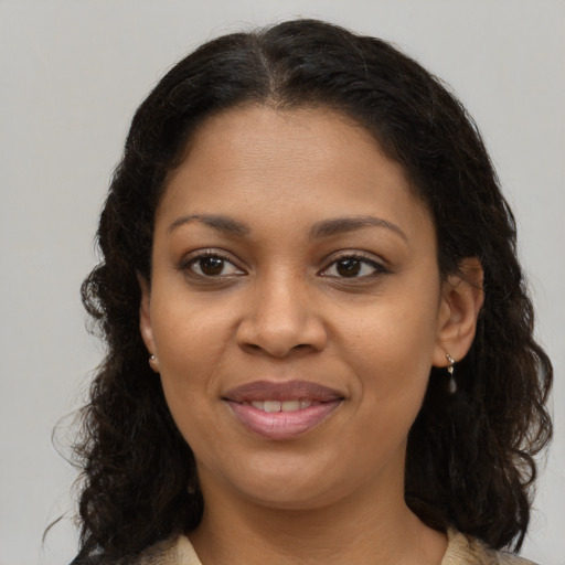 Joyful black young-adult female with medium  brown hair and brown eyes