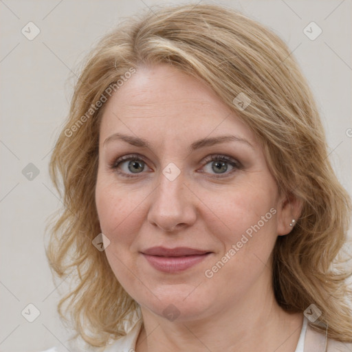 Joyful white adult female with medium  brown hair and blue eyes