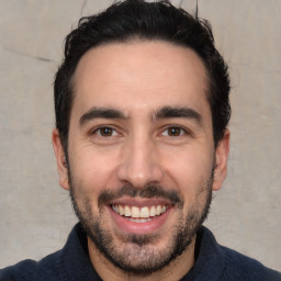 Joyful white young-adult male with short  black hair and brown eyes