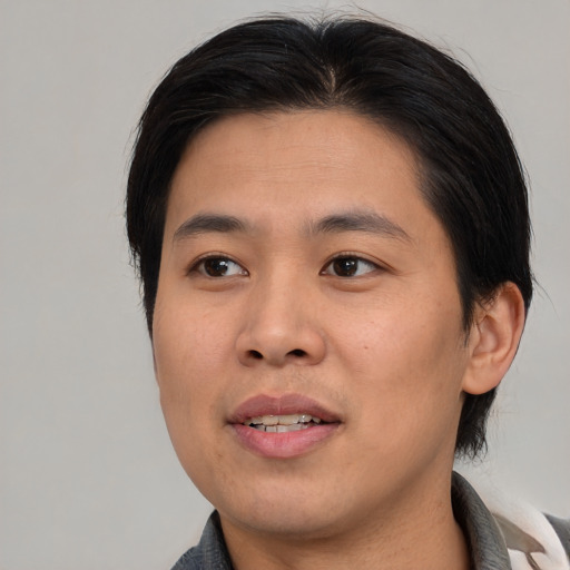 Joyful asian young-adult male with medium  brown hair and brown eyes
