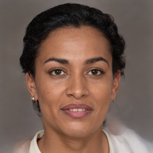 Joyful latino adult female with short  brown hair and brown eyes