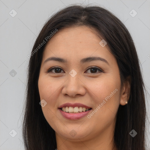 Joyful asian young-adult female with long  brown hair and brown eyes