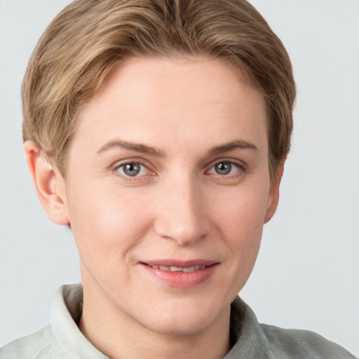 Joyful white young-adult female with short  brown hair and grey eyes