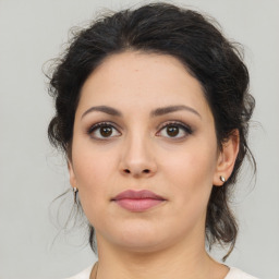 Joyful latino young-adult female with medium  brown hair and brown eyes