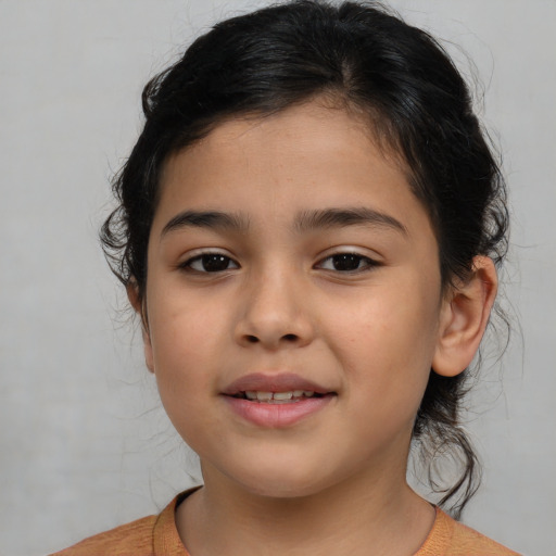 Joyful latino child female with medium  brown hair and brown eyes