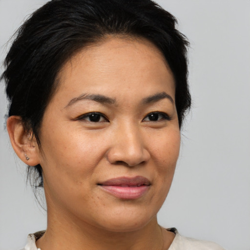 Joyful asian young-adult female with medium  brown hair and brown eyes