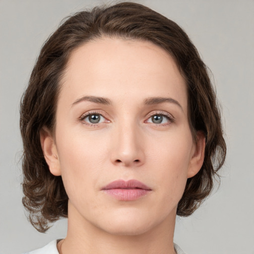 Neutral white young-adult female with medium  brown hair and green eyes