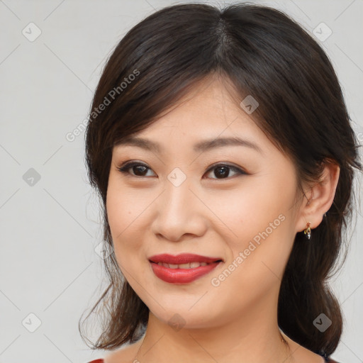 Joyful asian young-adult female with medium  brown hair and brown eyes