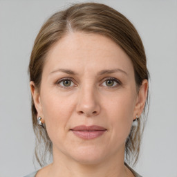 Joyful white adult female with medium  brown hair and grey eyes