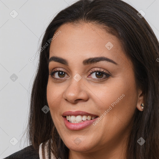 Joyful white young-adult female with long  brown hair and brown eyes