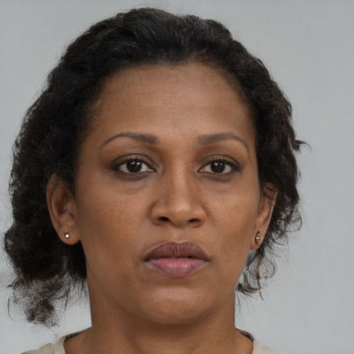 Neutral black adult female with medium  brown hair and brown eyes