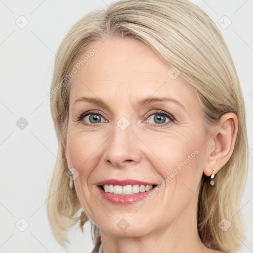 Joyful white adult female with medium  brown hair and grey eyes