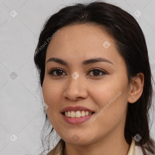 Joyful latino young-adult female with medium  brown hair and brown eyes