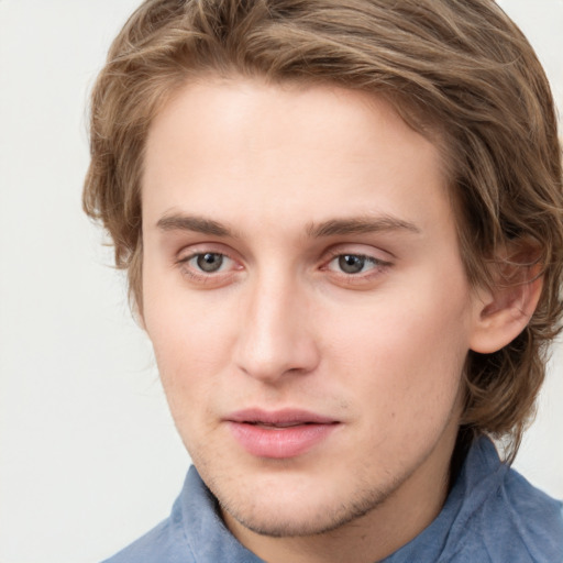 Joyful white young-adult male with medium  brown hair and blue eyes