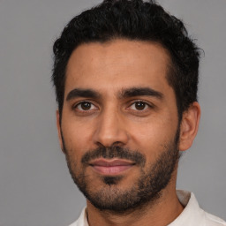 Joyful latino young-adult male with short  black hair and brown eyes