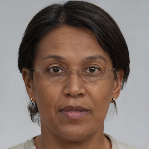 Joyful black adult female with medium  brown hair and brown eyes