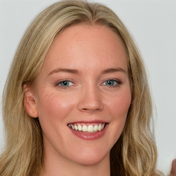 Joyful white young-adult female with long  brown hair and blue eyes