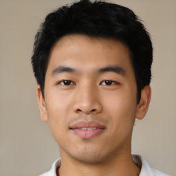 Joyful asian young-adult male with short  black hair and brown eyes