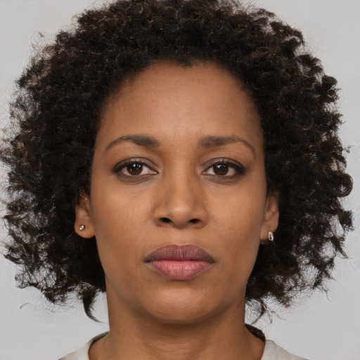 Neutral black young-adult female with medium  brown hair and brown eyes