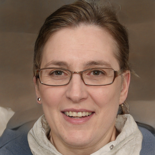 Joyful white adult female with medium  brown hair and blue eyes