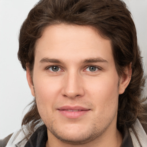 Joyful white young-adult male with medium  brown hair and brown eyes