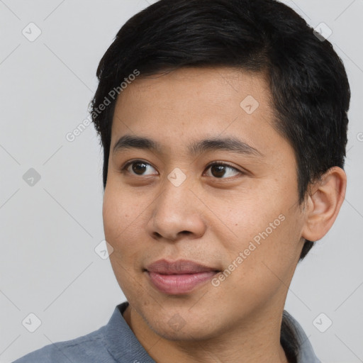 Joyful asian young-adult male with short  black hair and brown eyes