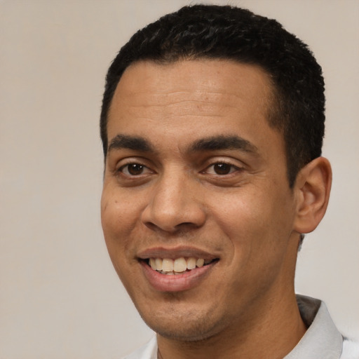 Joyful white young-adult male with short  black hair and brown eyes