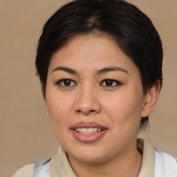 Joyful asian young-adult female with medium  brown hair and brown eyes