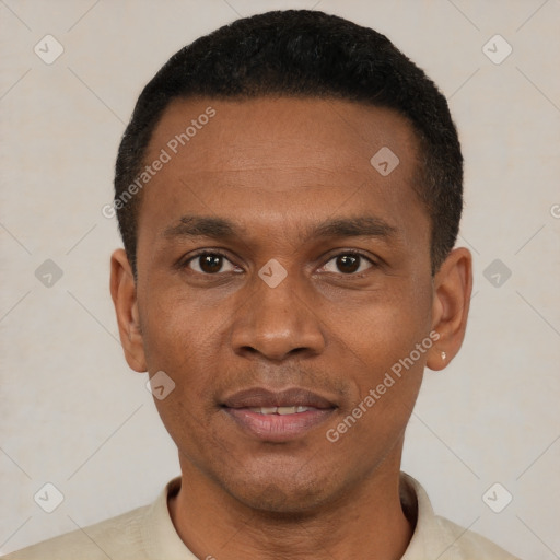 Joyful black young-adult male with short  black hair and brown eyes